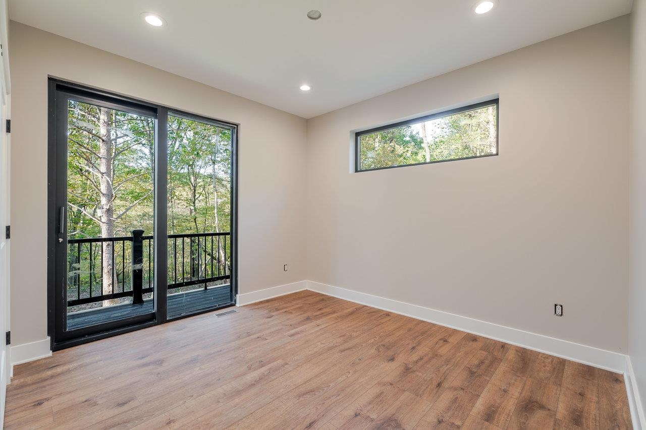 209 Beaver Road Basye, VA 22842 - Photo 31 of 68 a view of an empty room with wooden floor and a window