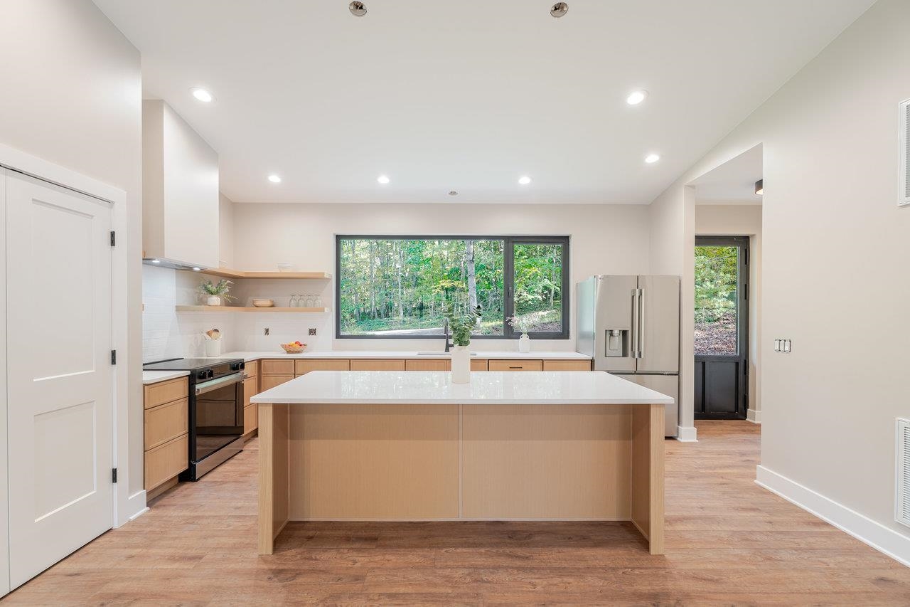 209 Beaver Road Basye, VA 22842 - Photo 9 of 68 a large kitchen with stainless steel appliances granite countertop a stove a sink and a refrigerator