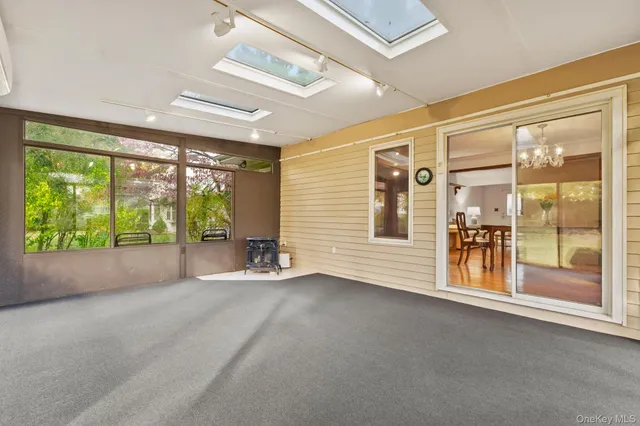 a bed sitting in a room next to a large window