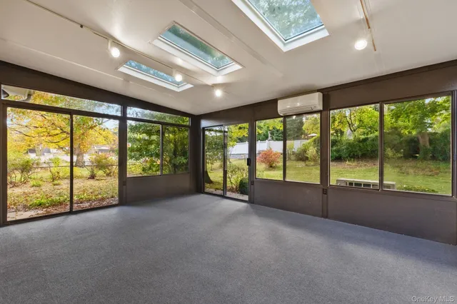 a view of empty room with floor to ceiling window and doors