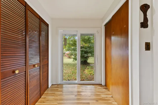 a room with large window and furniture