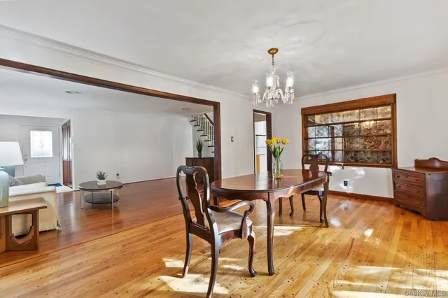 a view of a dining room with furniture wooden floor and a chandelier
