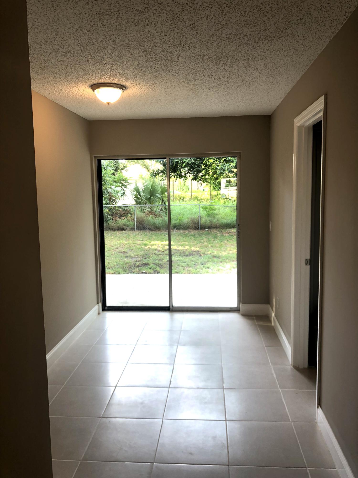 253 Southeast Norfolk Boulevard Stuart, FL 34997 - Photo 12 of 16 a view of an empty room with a window