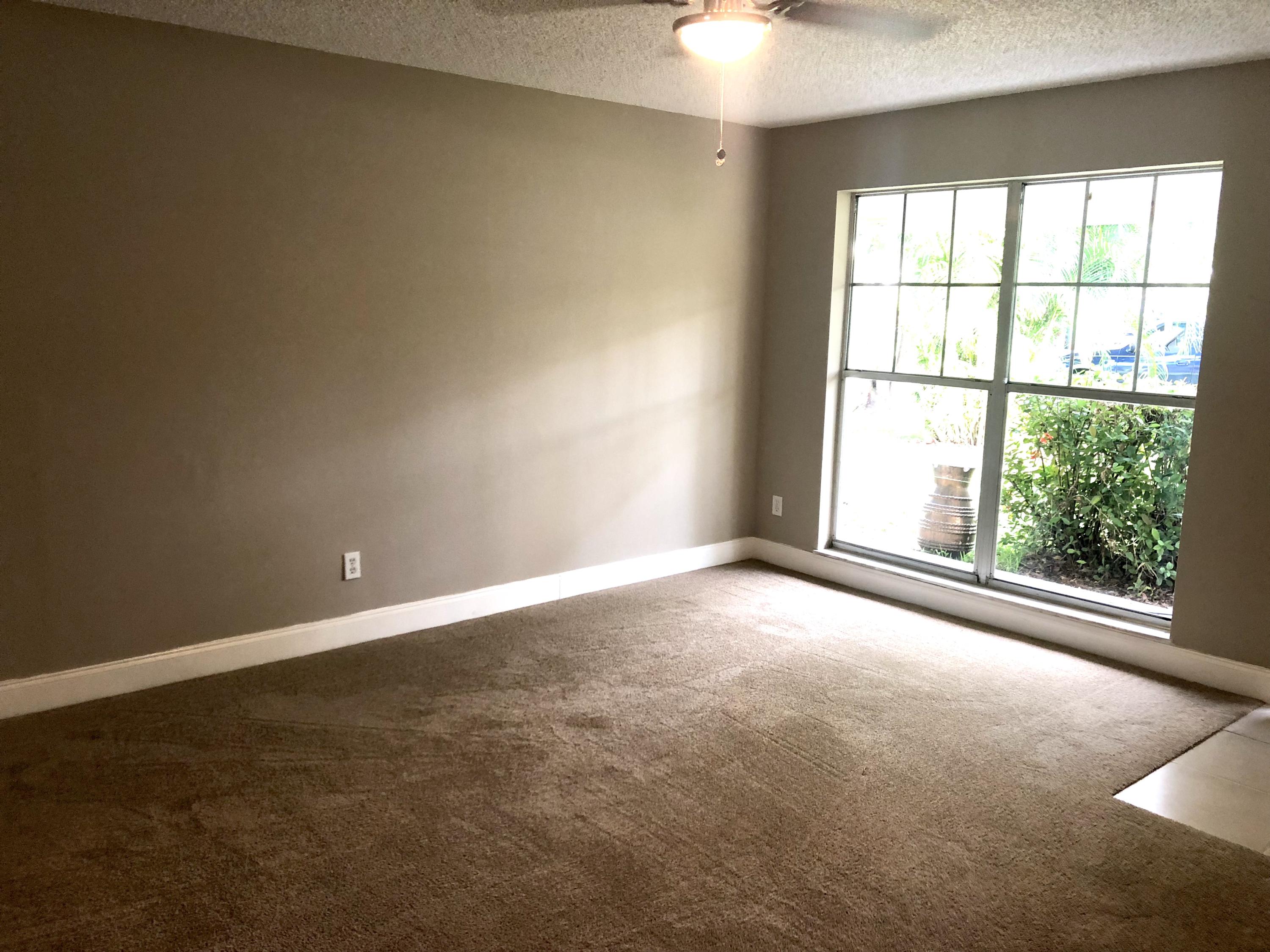 253 Southeast Norfolk Boulevard Stuart, FL 34997 - Photo 14 of 16 an empty room with an empty space and a window