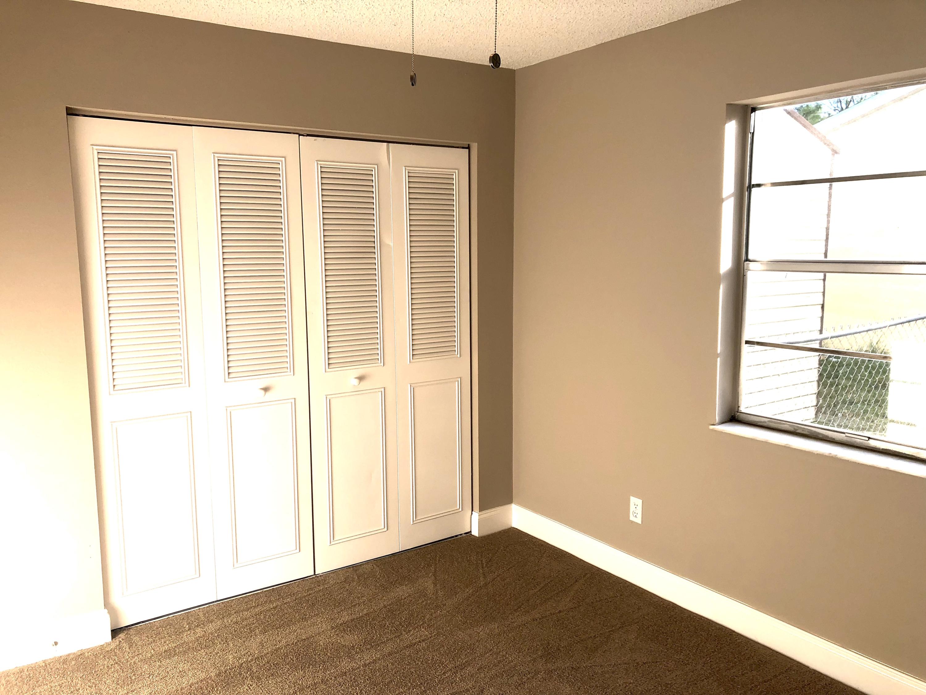 253 Southeast Norfolk Boulevard Stuart, FL 34997 - Photo 6 of 16 a view of an empty room with a window