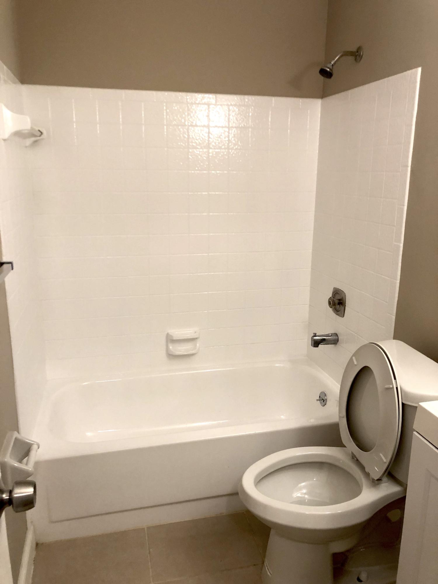 253 Southeast Norfolk Boulevard Stuart, FL 34997 - Photo 7 of 16 a bathroom with a granite countertop toilet sink and mirror