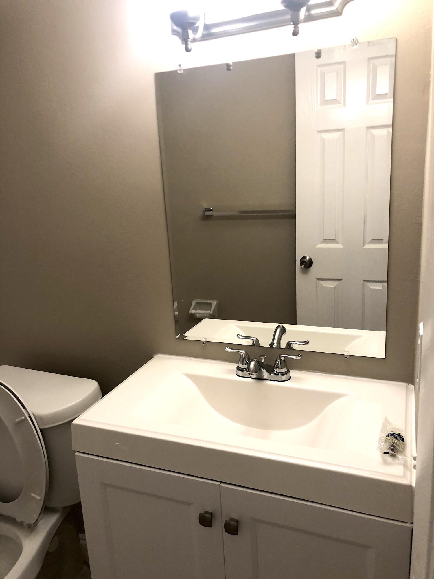253 Southeast Norfolk Boulevard Stuart, FL 34997 - Photo 8 of 16 a bathroom with a sink and a mirror