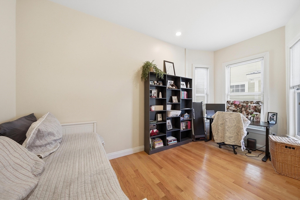 48-50 Carleton Street Newton, MA 02458 - Photo 13 of 19 a bedroom with a bed and a chair
