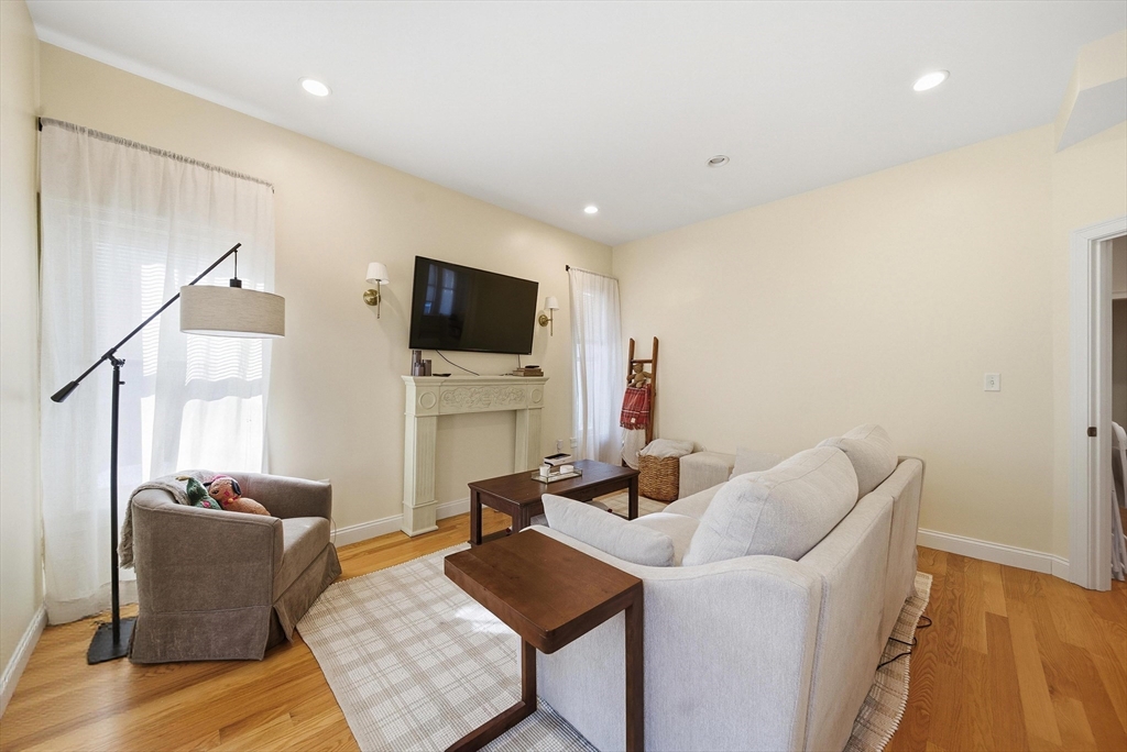 48-50 Carleton Street Newton, MA 02458 - Photo 14 of 19 a living room with furniture and a flat screen tv