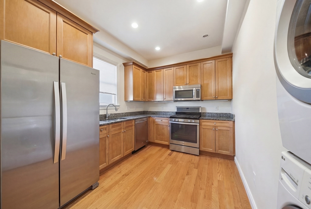 48-50 Carleton Street Newton, MA 02458 - Photo 2 of 19 a kitchen with stainless steel appliances granite countertop a refrigerator sink and microwave