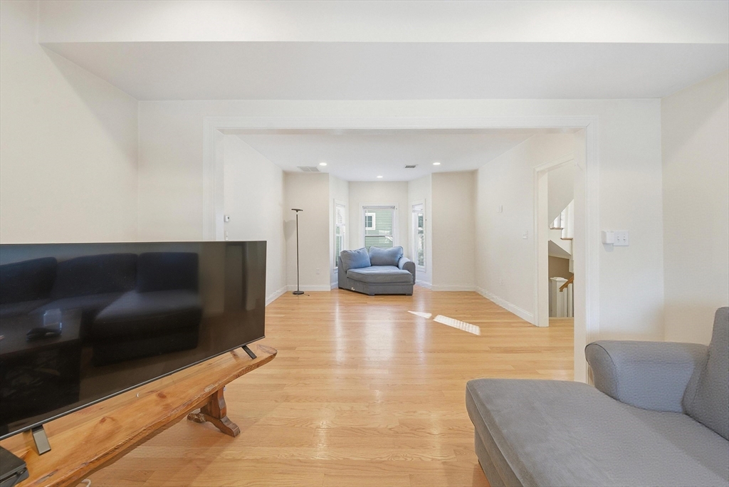 48-50 Carleton Street Newton, MA 02458 - Photo 3 of 19 a living room with furniture and a flat screen tv