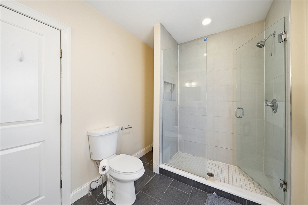 48-50 Carleton Street Newton, MA 02458 - Photo 9 of 19 a bathroom with a toilet and a shower