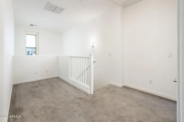 a kitchen with stainless steel appliances a sink a stove a refrigerator cabinets and a window