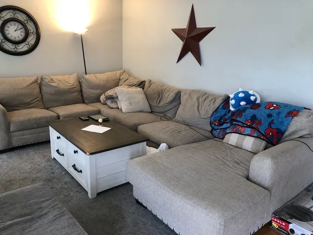 a living room with furniture and a rug