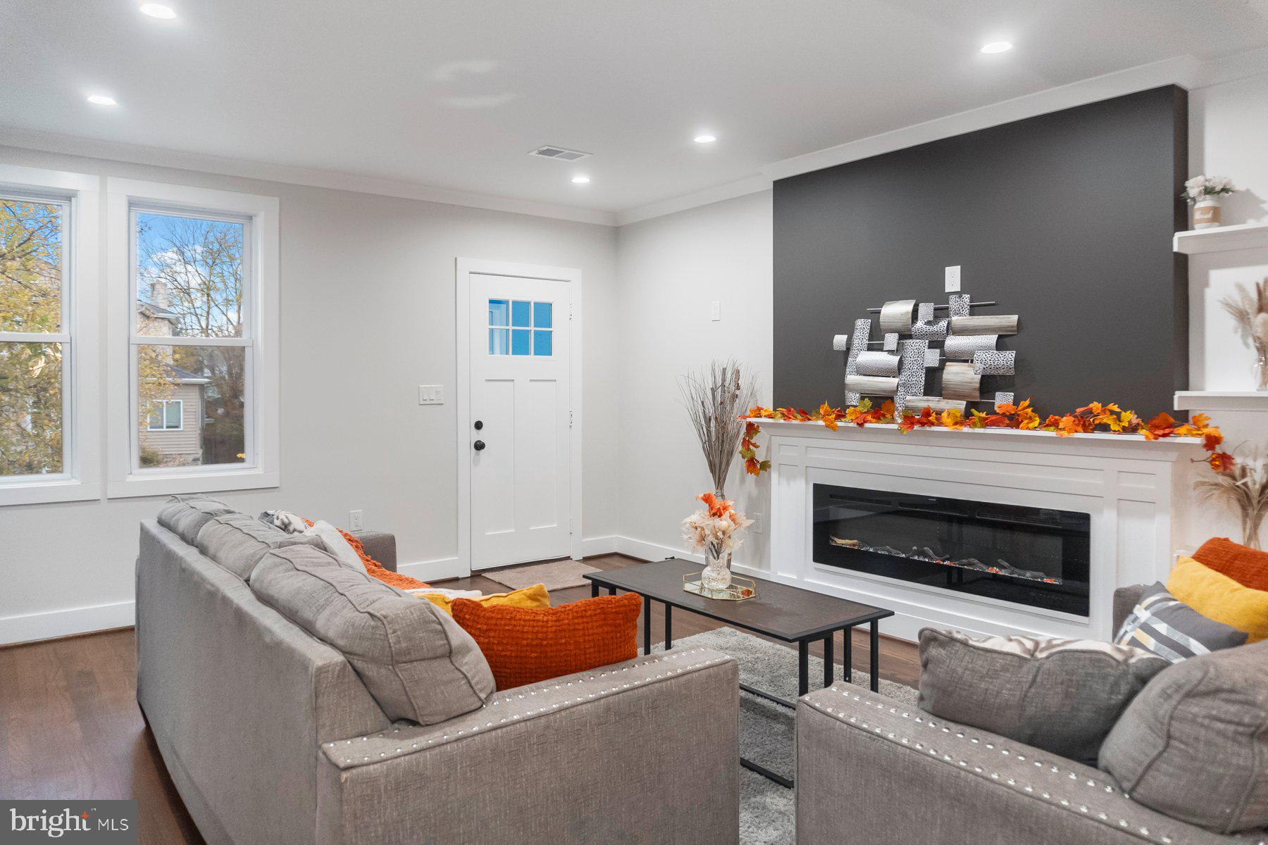 5216 Biddison Lane Baltimore, MD 21206 - Photo 11 of 32 a living room with furniture fireplace and a window