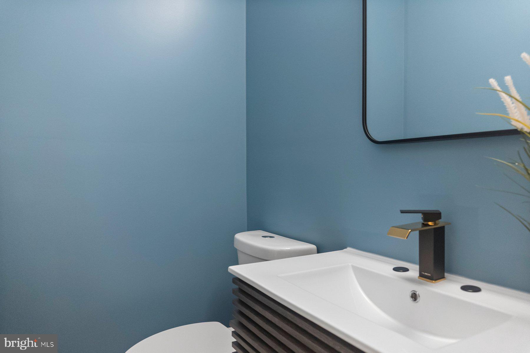 5216 Biddison Lane Baltimore, MD 21206 - Photo 12 of 32 a bathroom with a sink and a toilet