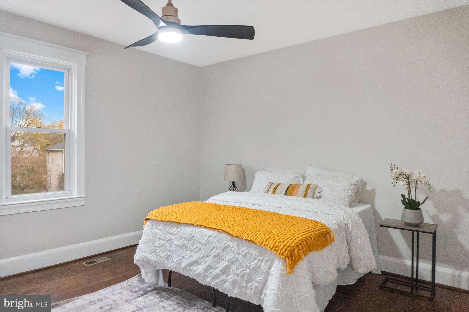 5216 Biddison Lane Baltimore, MD 21206 - Photo 13 of 32 a bed sitting in a bedroom next to a window