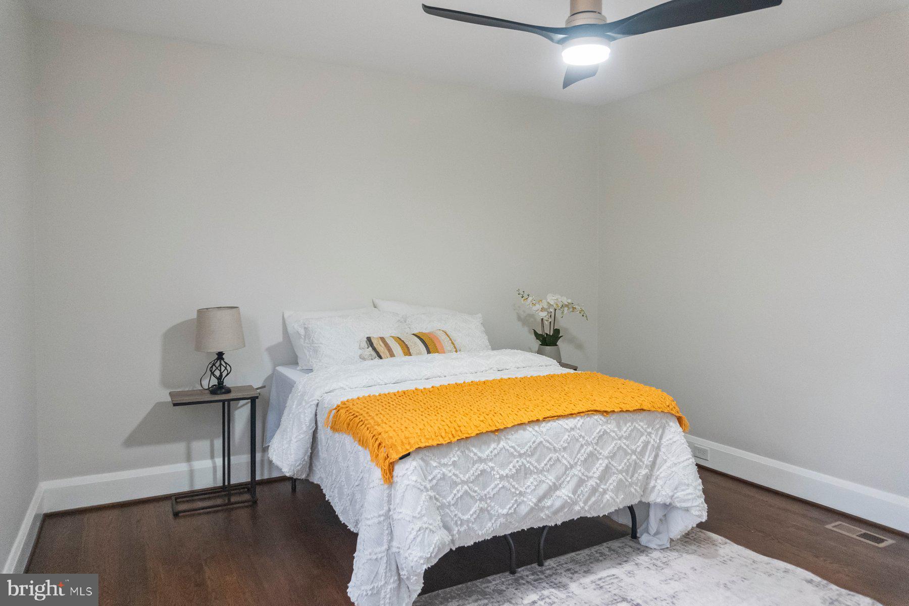 5216 Biddison Lane Baltimore, MD 21206 - Photo 14 of 32 a bedroom with a bed and a table in it