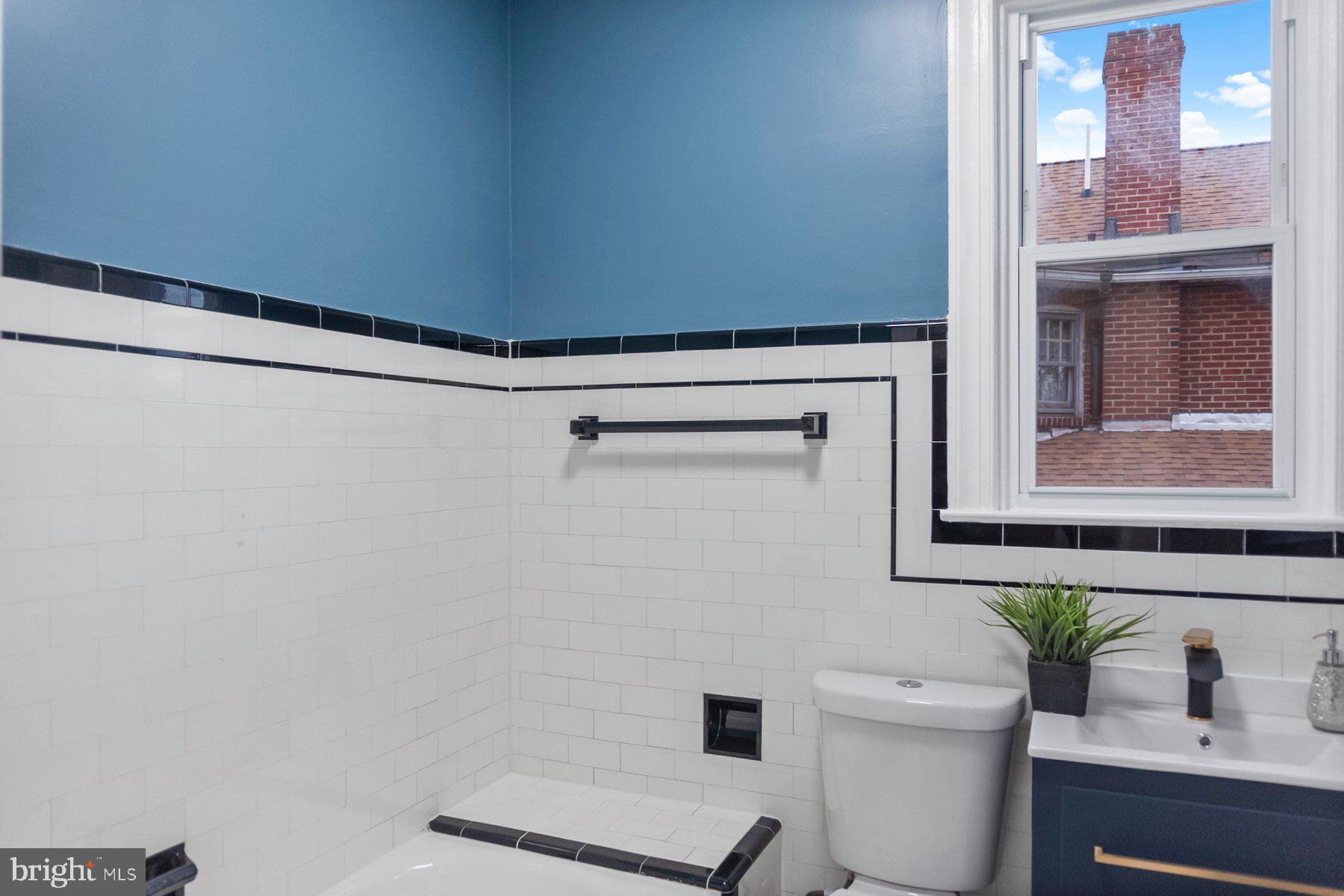 5216 Biddison Lane Baltimore, MD 21206 - Photo 15 of 32 a bathroom with a toilet and a sink