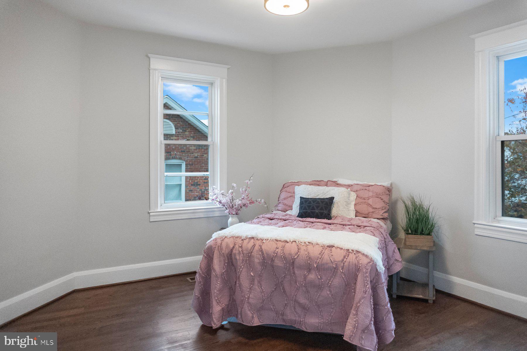 5216 Biddison Lane Baltimore, MD 21206 - Photo 16 of 32 a bedroom with a bed and a window