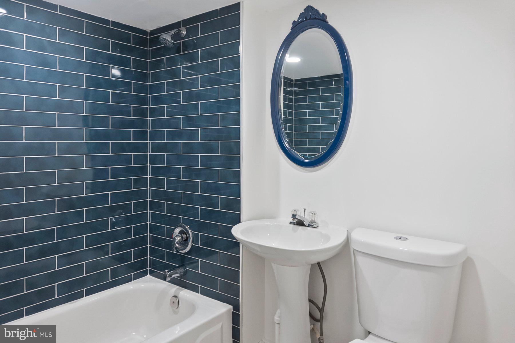 5216 Biddison Lane Baltimore, MD 21206 - Photo 20 of 32 a bathroom with a sink mirror toilet and bathtub