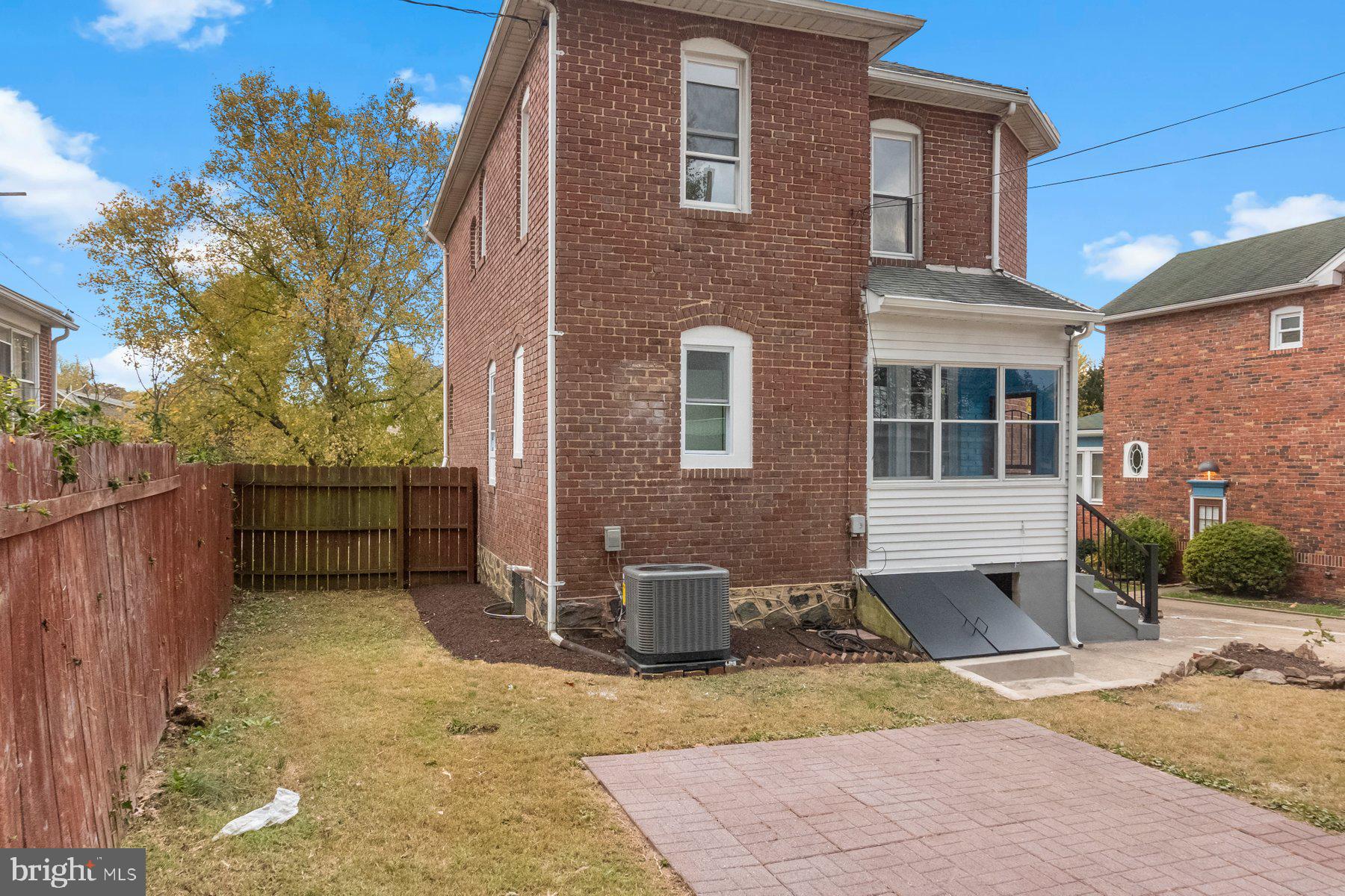 5216 Biddison Lane Baltimore, MD 21206 - Photo 27 of 32 a view of a house with a small yard and wooden fence