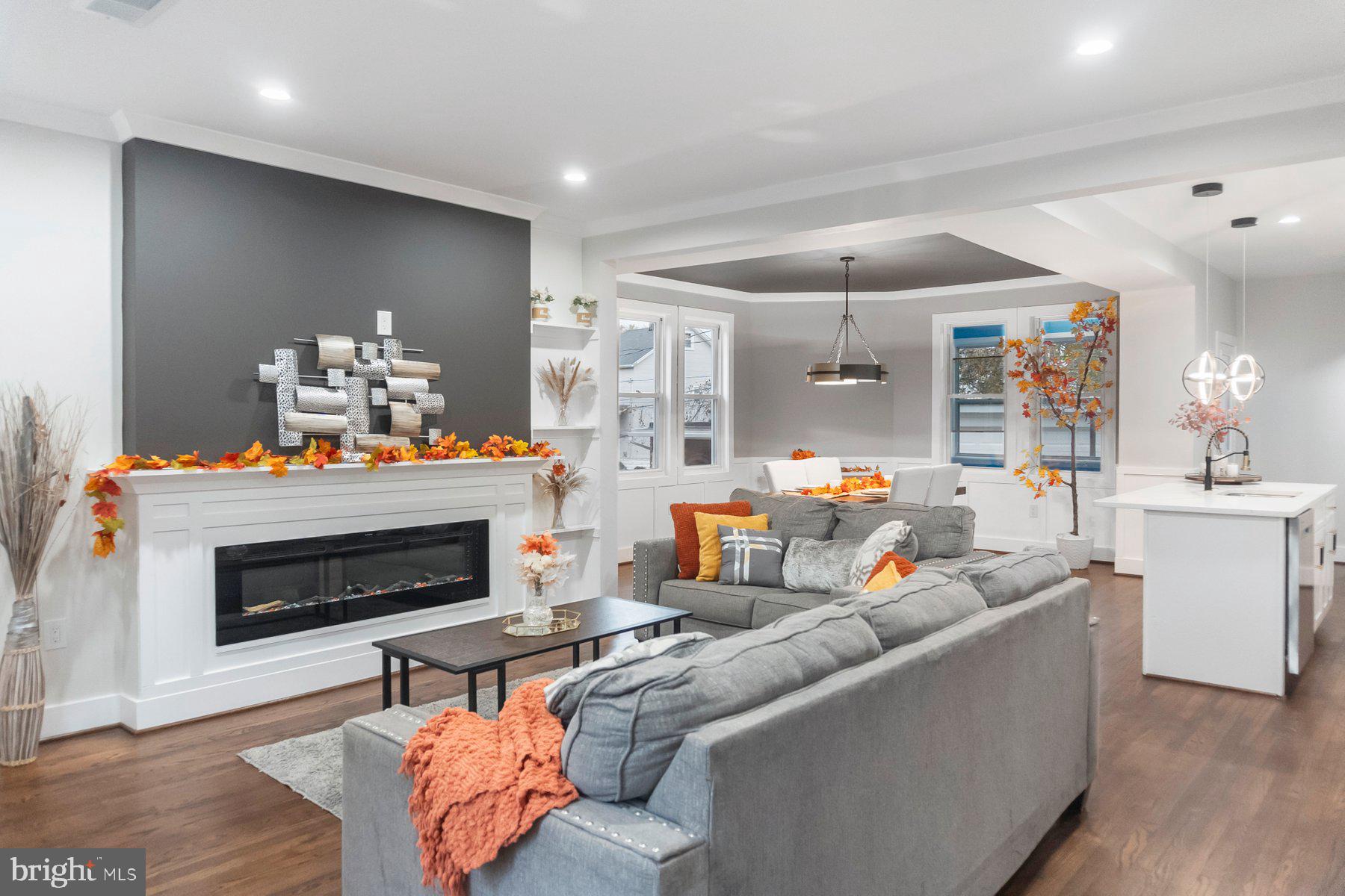 5216 Biddison Lane Baltimore, MD 21206 - Photo 4 of 32 a living room with furniture a fireplace and a chandelier