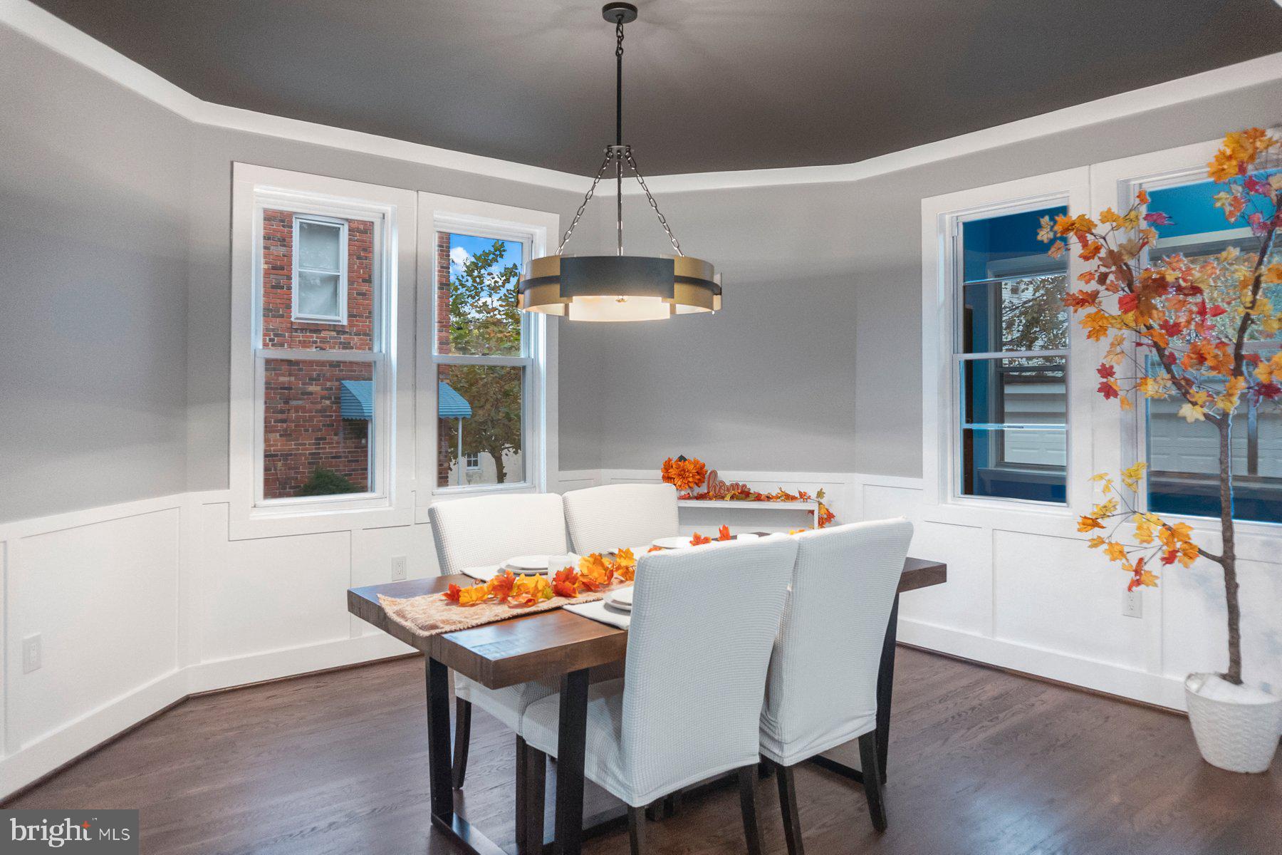5216 Biddison Lane Baltimore, MD 21206 - Photo 6 of 32 a view of a dining room with furniture wooden floor and a chandelier