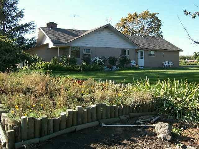 251 Phipps Road Outlook, WA 98938 - Photo 1 of 6 a front view of a house with garden