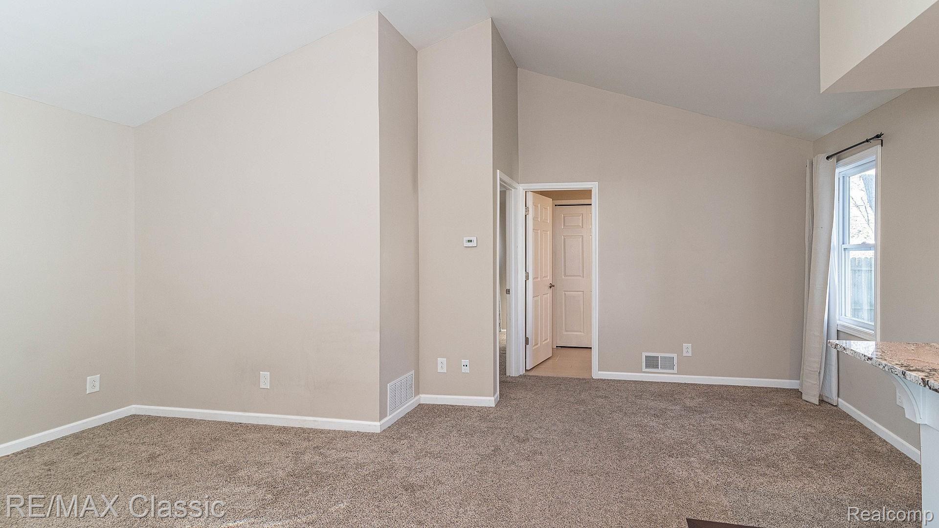 134 Oriole Road Commerce Township, MI 48382 - Photo 12 of 23 Oriole Living room to bedroom and bath.jpg