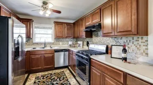 a kitchen with stainless steel appliances granite countertop a sink stove and refrigerator