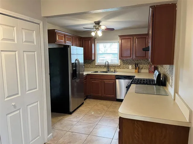 a kitchen with a sink a stove and refrigerator