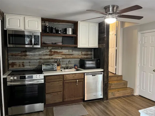 a kitchen with stainless steel appliances granite countertop a stove and a refrigerator