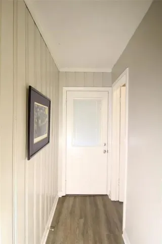 a view of a hallway with wooden floor and closet