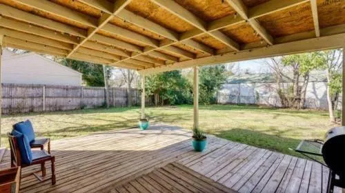 a view of a backyard with swimming pool