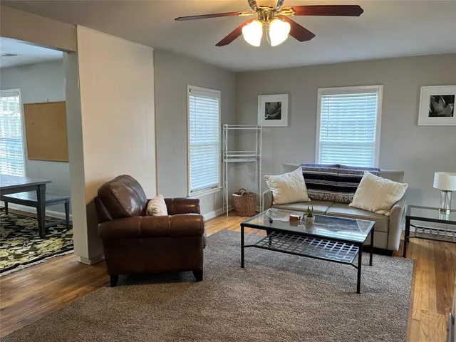 a living room with furniture and a chandelier