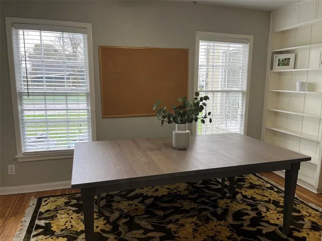 a view of a dining room with a table and chairs