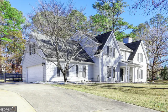 front view of a house with a big yard and large trees