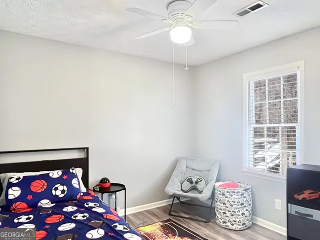 a view of a workspace with furniture and a ceiling fan