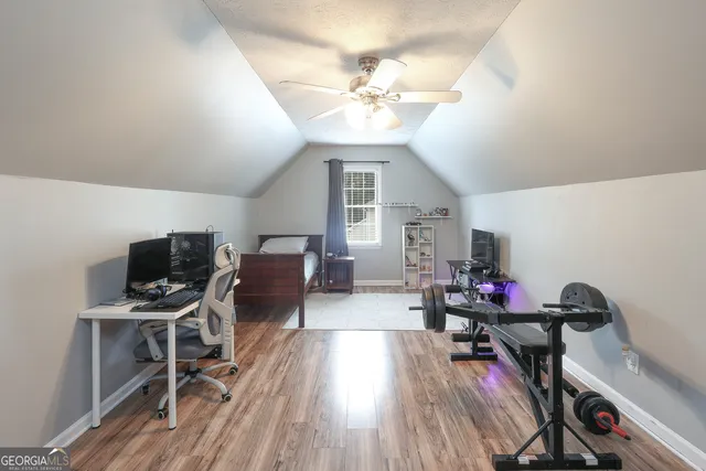 a view of a workspace with furniture and wooden floor
