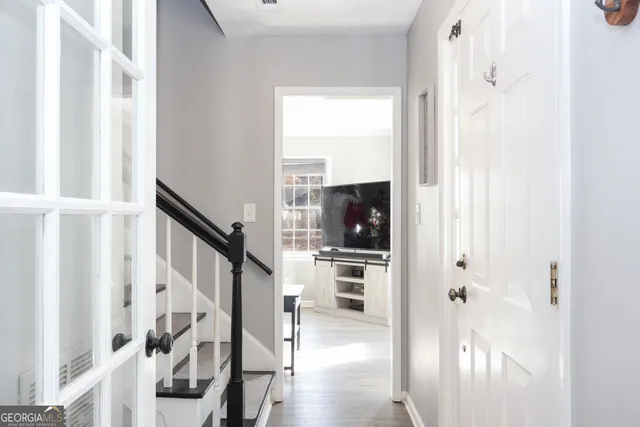 a view of entryway and hall with wooden floor