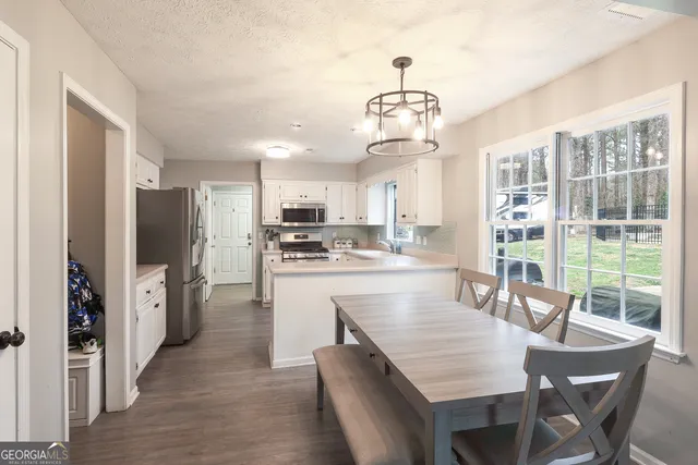 a kitchen with stainless steel appliances granite countertop a sink a stove and a refrigerator