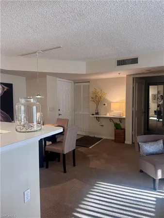 a view of a dining room with furniture and window