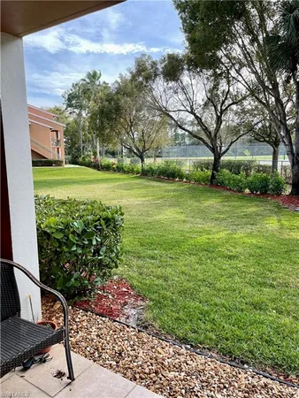 a view of a backyard and swimming pool