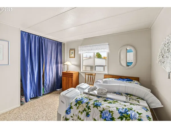 a bedroom with a bed and a lamp with window