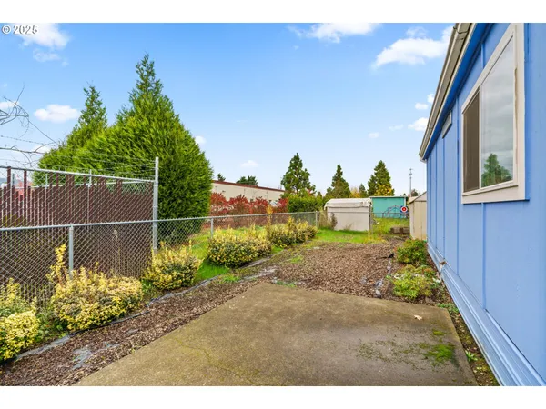 a front view of a house with a yard and a garden
