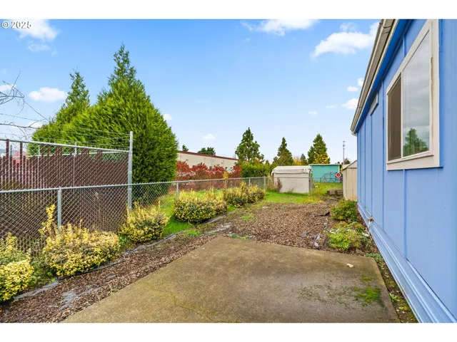 a front view of a house with a yard and a garden