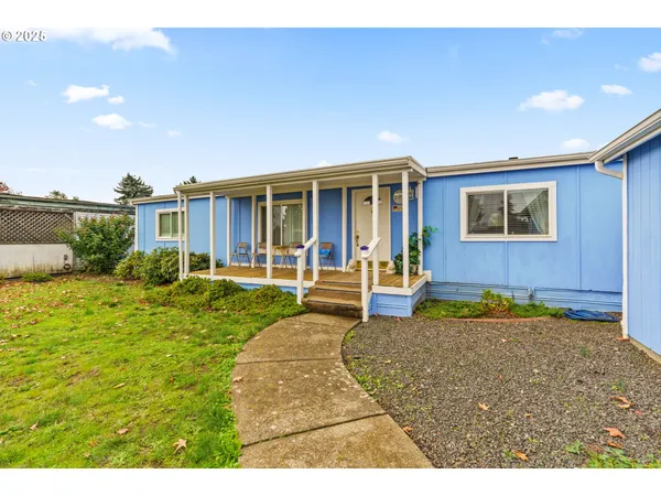 a view of a house with backyard porch and sitting area