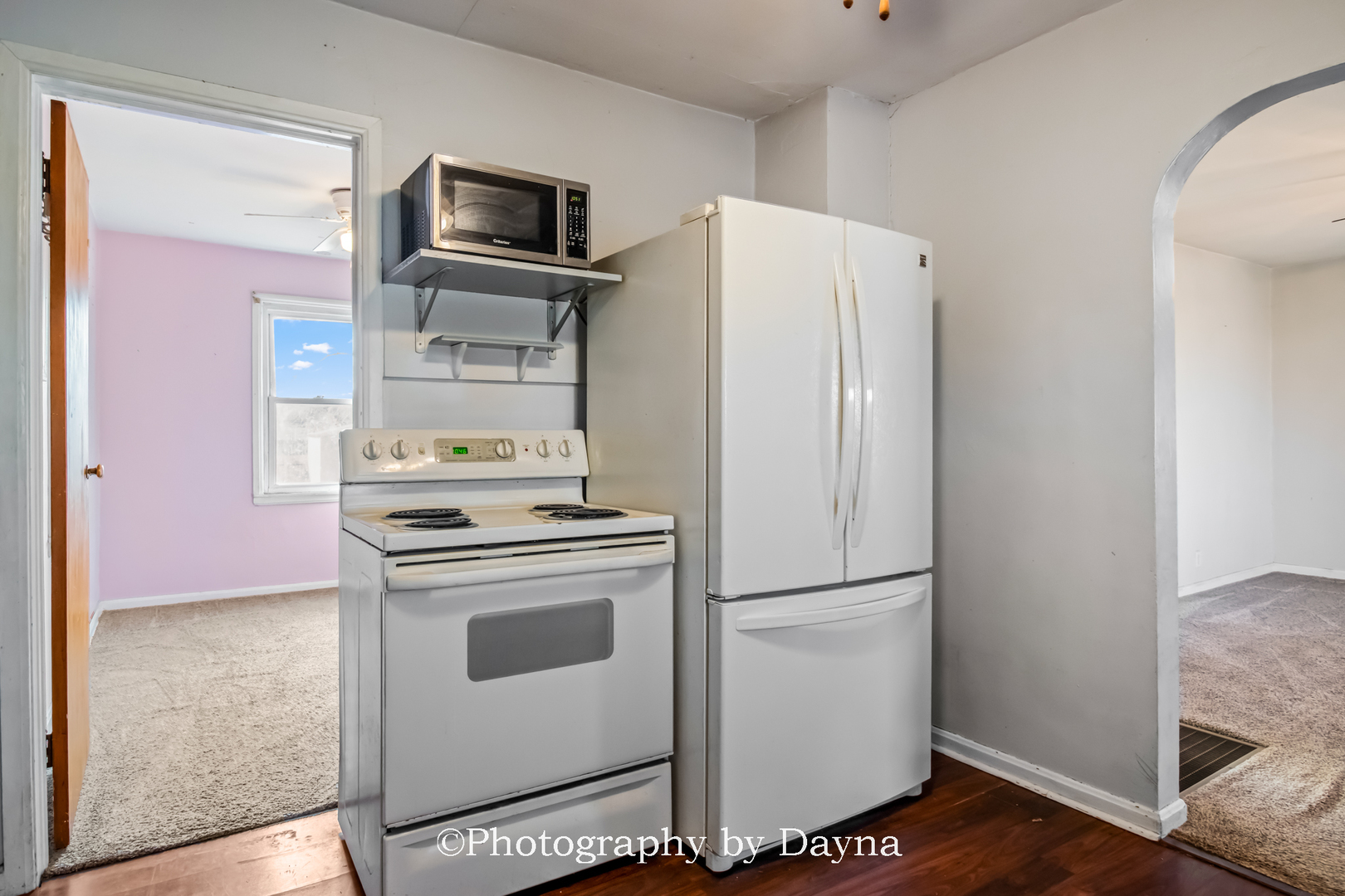 317 Thomas Street Martinton, IL 60951 - Photo 5 of 22 a white refrigerator freezer and a stove sitting inside of a kitchen