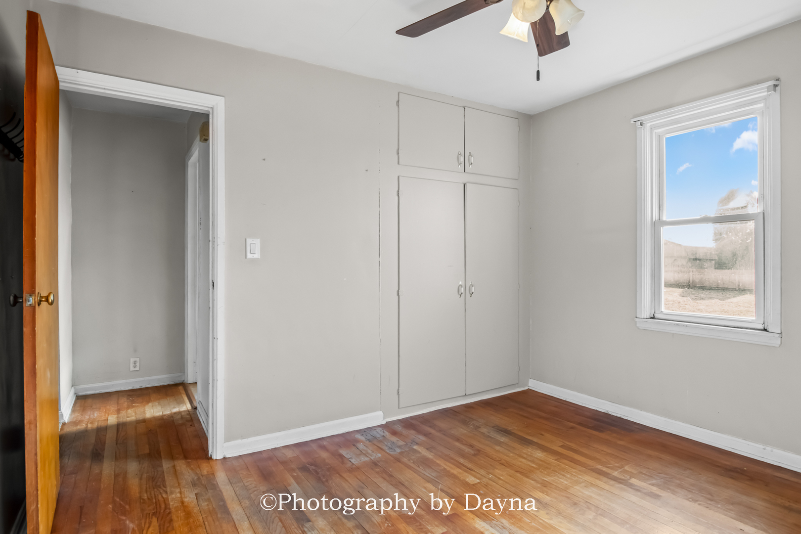 317 Thomas Street Martinton, IL 60951 - Photo 7 of 22 a view of an empty room with wooden floor and a window